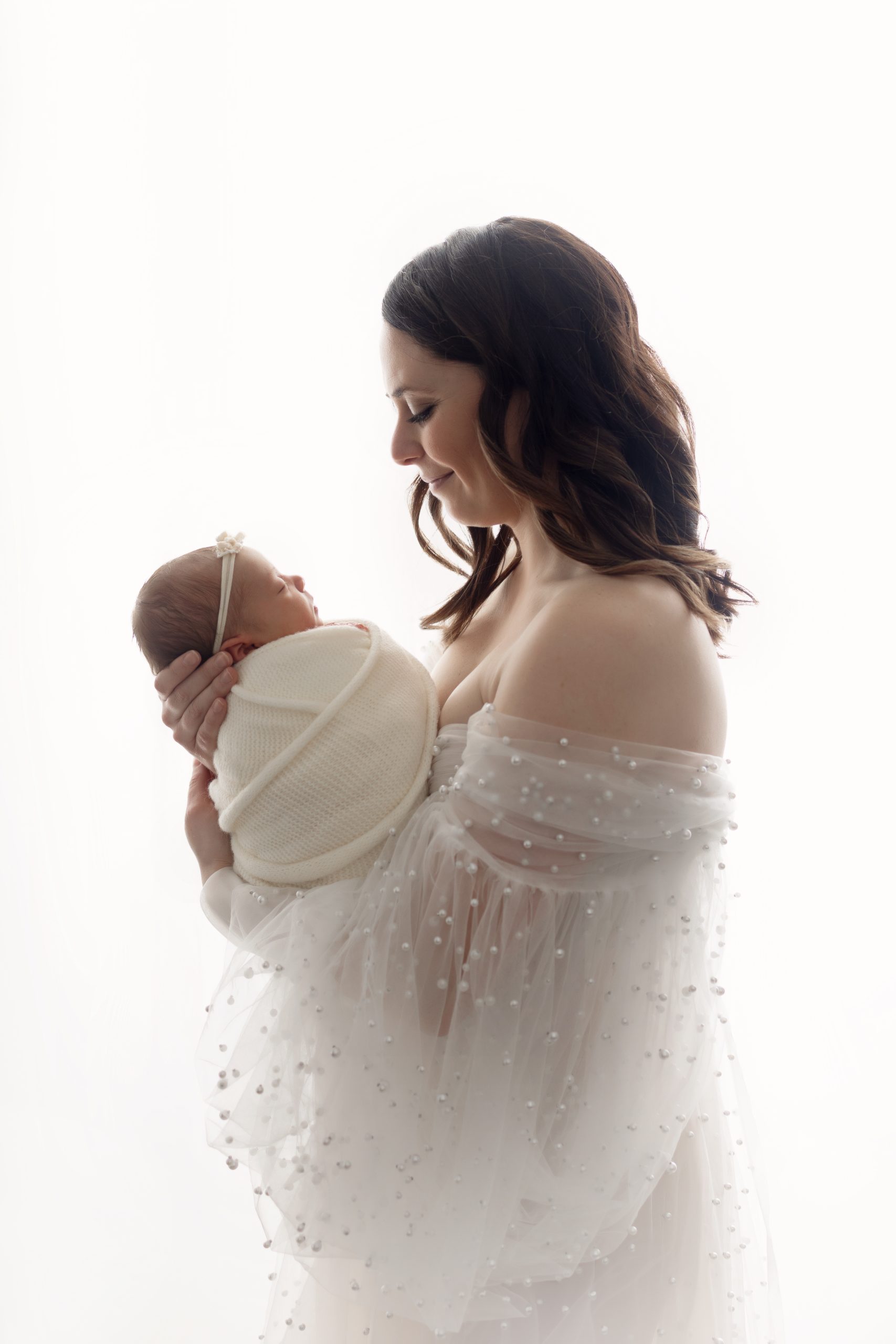 Close, connected pose highlighting newborn features.