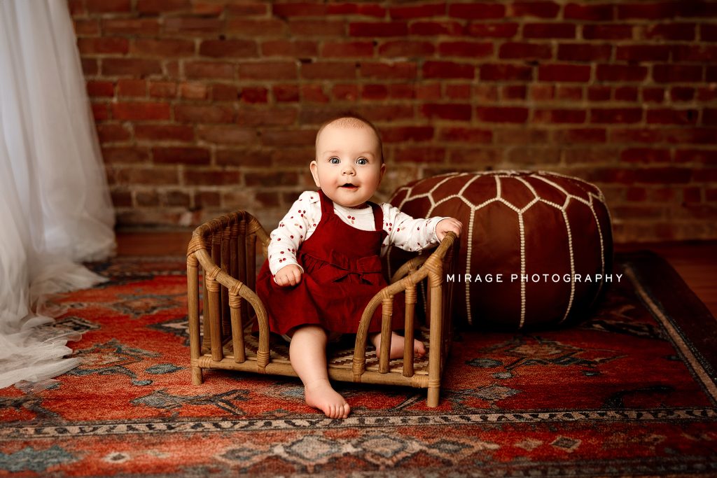 baby girl in basket in photo studio