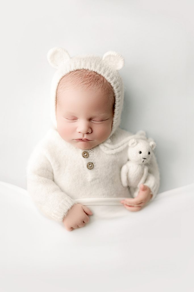 newborn baby on white background in a studio at Fowlerville, MI