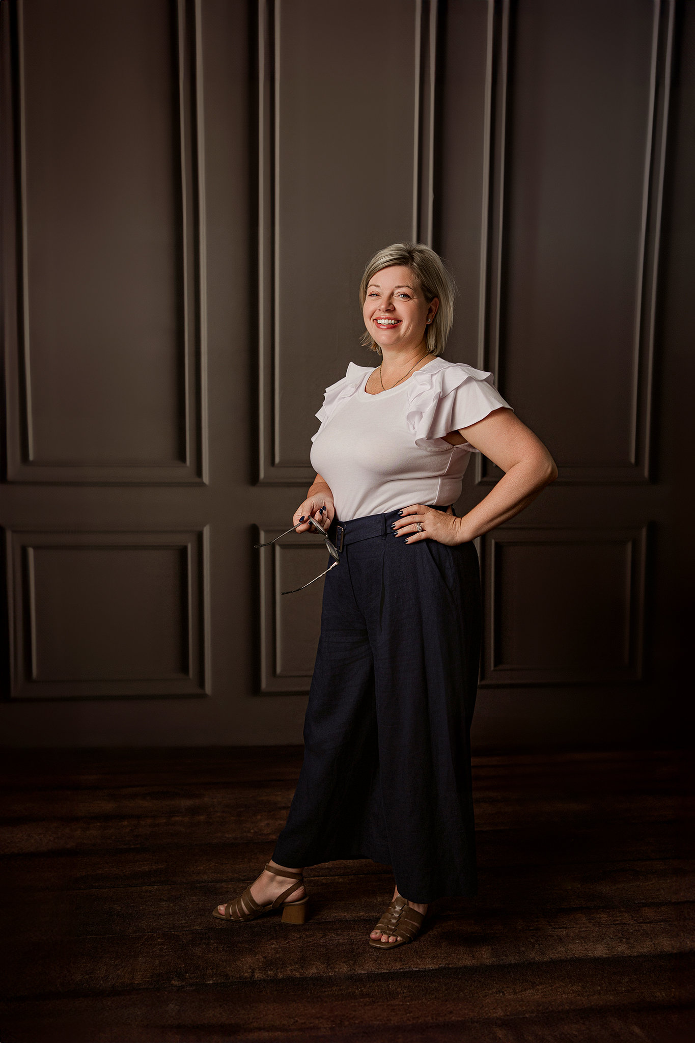 Professional headshot with a modern office background