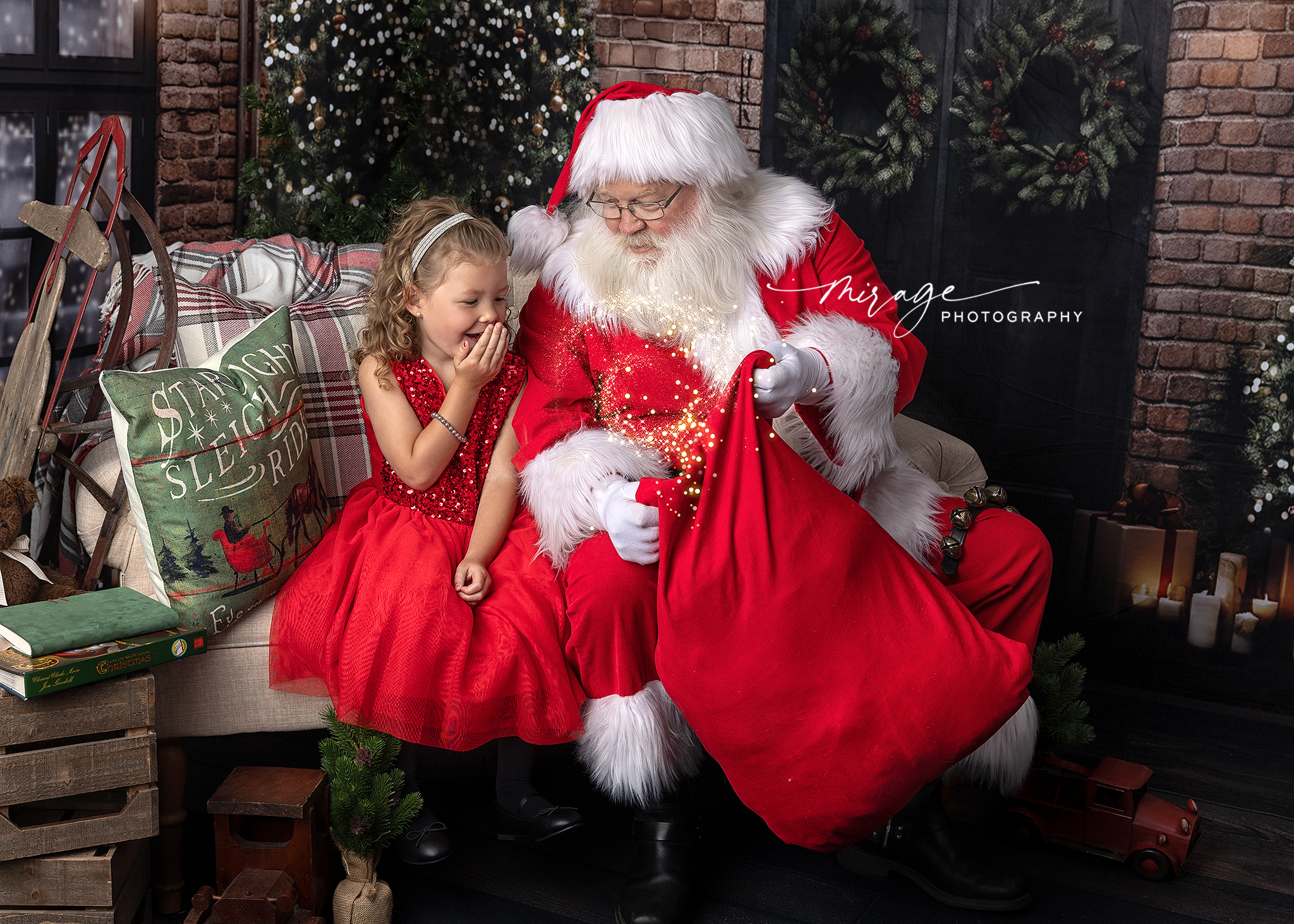 Little girl in a red dress sharing a magical moment with Santa