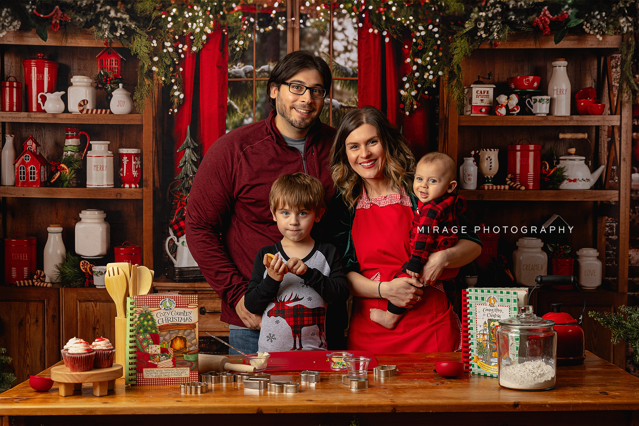 Siblings at the Mistletoe Market backdrop with twinkle lights and wrapped gifts
