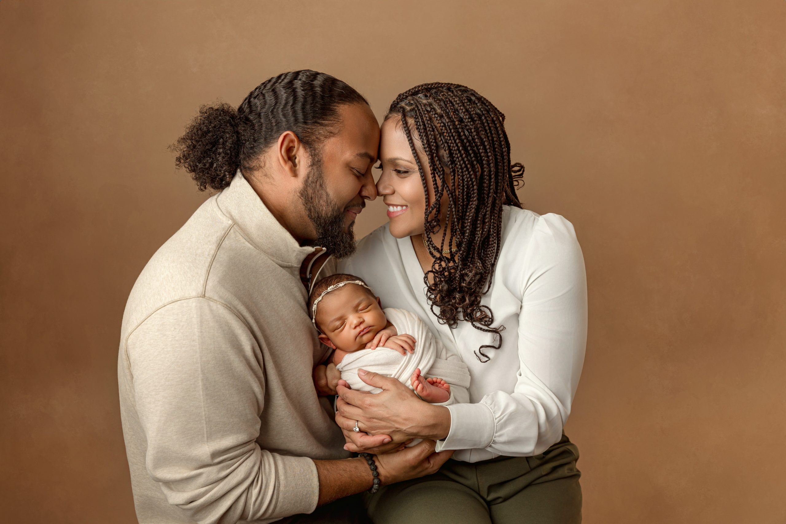 Sibling gently holding newborn in safe, supported pose.