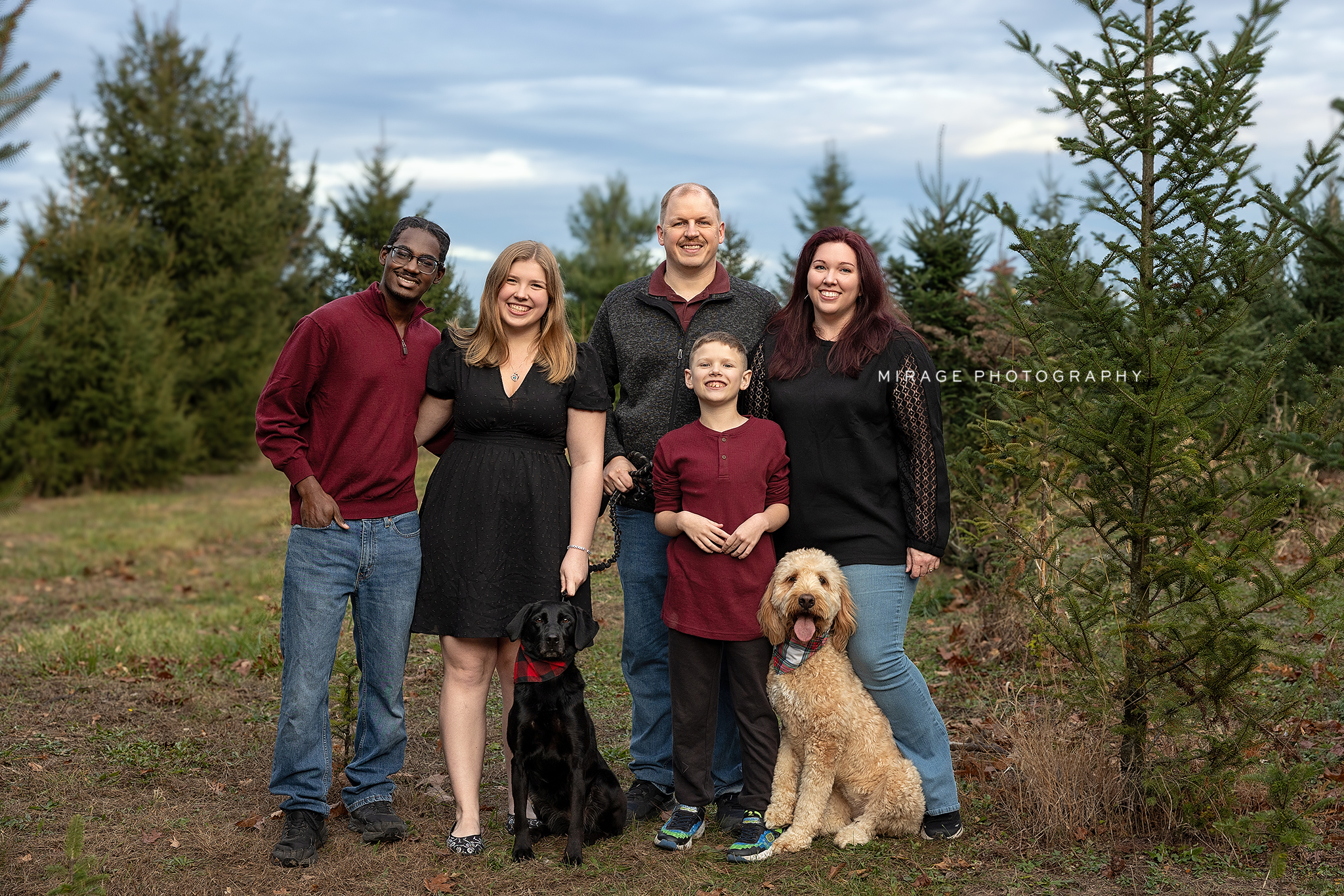 Family portrait on the treefarm set at Mirage Photography Studio, Webberville MI