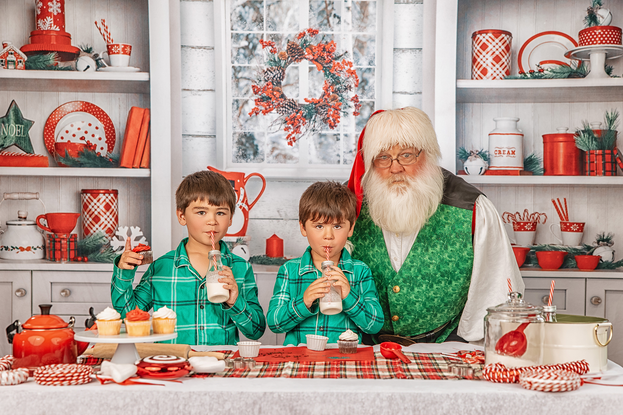 Two boys drinking milk with cookies in a festive Christmas kitchen set
