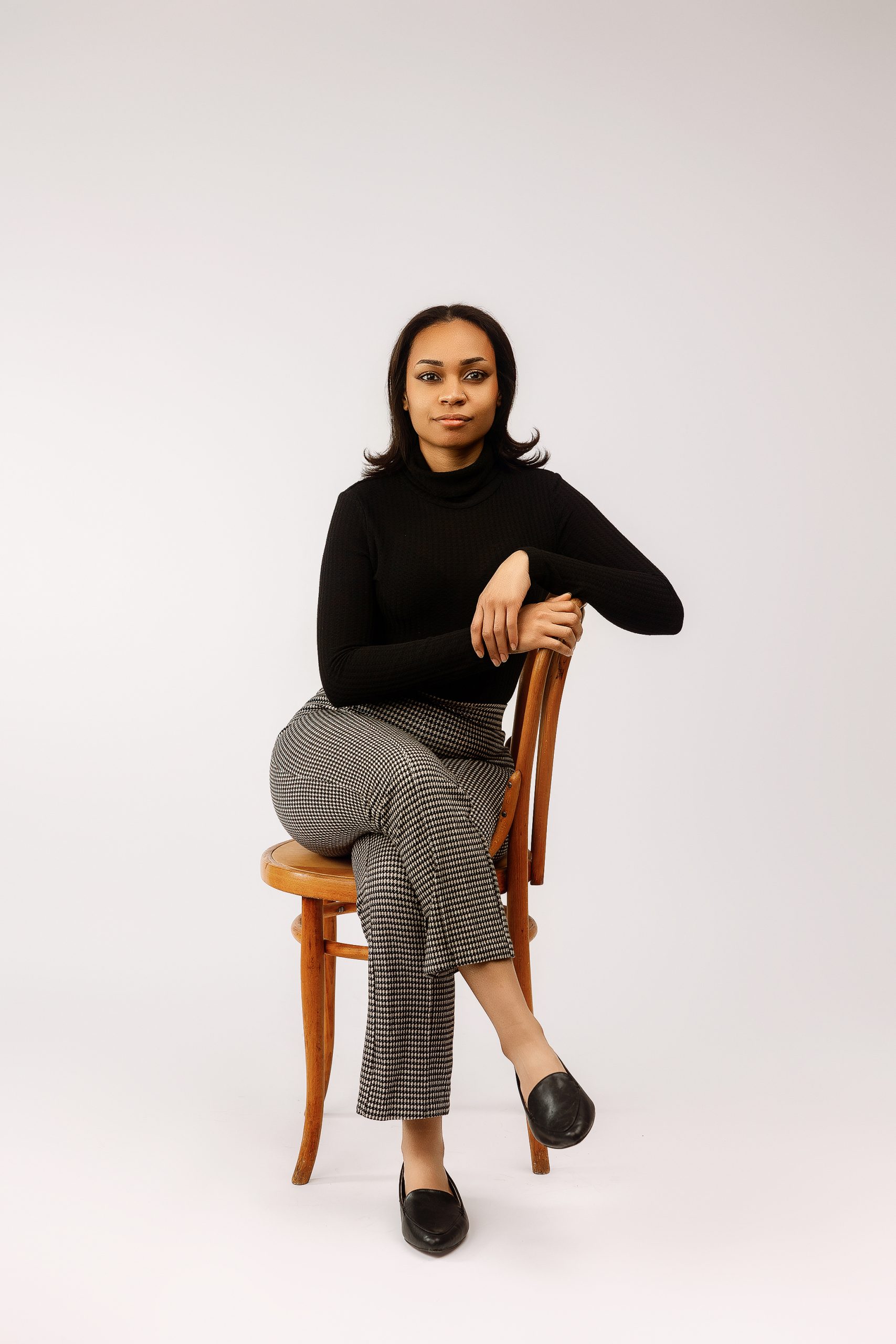 Professional headshot standing pose with chair